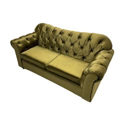 Chesterfield shaped two seat sofa, upholstered in buttoned olive fabric, with scatter cushions