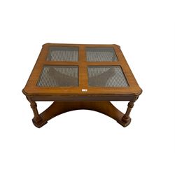 Coffee table, square top with cane work insets, raised on four fluted column supports joined by shaped base