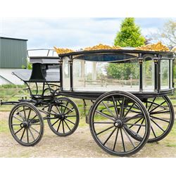 Victorian Glass Hearse

A black painted four wheeled horse drawn glass hearse with extensively glazed coffin compartment, etched glass side and end panels, decorative gilt cresting, gilt column capitals, white painted interior bier deck, metal coffin rails with cross finials, rear glazed access doors, external coachman's box seat for two, wooden spoked wheels the wheel hubs stamped 'The Economic Funeral Co', leaf spring suspension, underbody turntable steering and pole for driving with a pair of horses. The hearse has decorative painted lining throughout and an ornate black and gilt body with curved glass panels to the sides and rear.

Features

• Extensively glazed coffin compartment
• Etched glass side and end panels
• Decorative gilt cresting
• Gilt column capitals
• White painted interior bier deck
• Metal coffin rails with cross finials
• Rear glazed access doors
• External coachman's box seat
• Wooden spoked wheels
• Leaf spring suspension
• Underbody turntable steering
• Pole for driving with a pair of horses
• Decorative painted lining

Dimensions:
Overall length: 406 cm
Body length: 250 cm
Overall width: 190 cm
Body width: 115 cm
Height: 228 cm

Wheel Diameters:
Front wheels: 102 cm
Rear wheels: 133 cm

Seating

Coachman's box seat: 2
