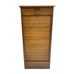 Early 20th century filing cabinet, moulded rectangular top over tambour roll door, fitted with nine document slides