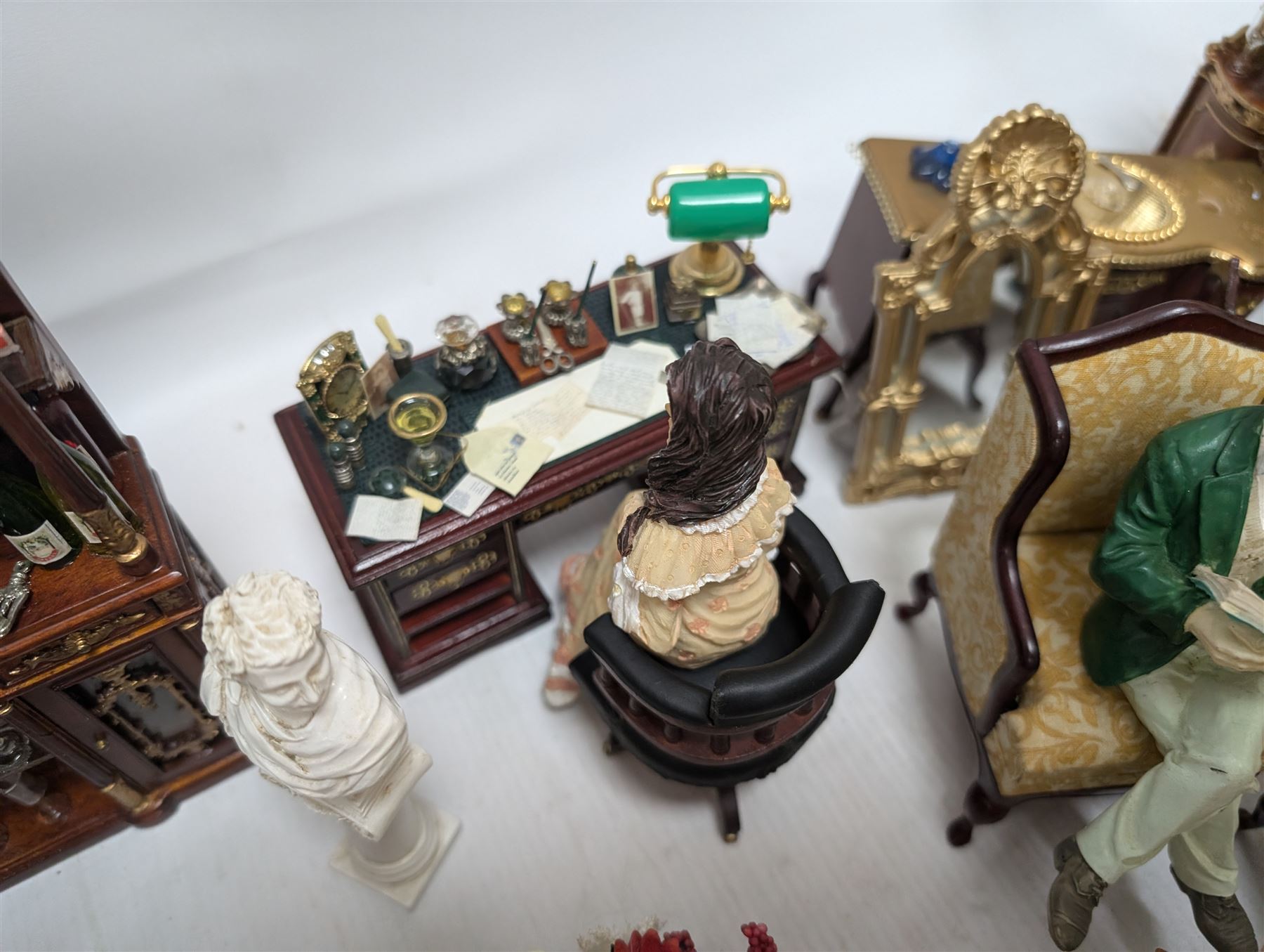 Dolls house living room and dining room furniture, including arm chairs, desk, fireplaces, dressers, tables, eight figures and a large collection of predominantly Christmas themed food, accessories and decorations