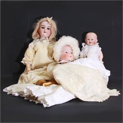 Two German bisque head dolls, to include a Franz Schmidt example with blue glass eyes and an Armand Marseille 590 example with applied hair, together with a Schoenau & Hoffmeister bisque doll's head, pair of doll's hands and a collection of clothing