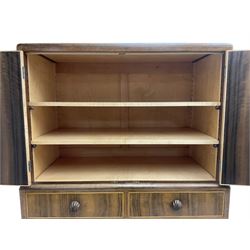 Early 20th century Art Deco walnut cocktail tallboy chest, fitted with double cupboard enclosing two shelves over two short and three long drawers, each with shell shaped handes