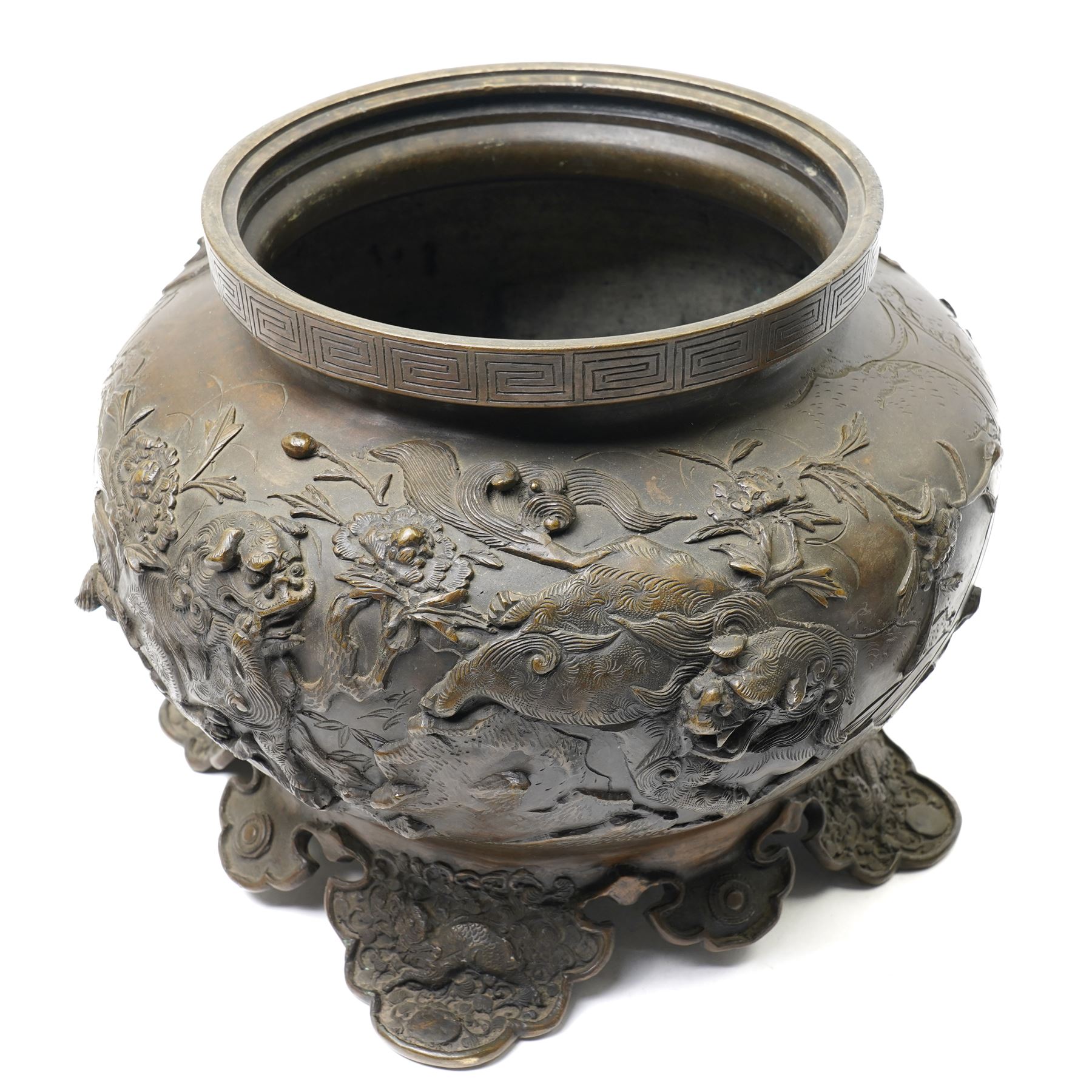 Japanese Meiji period bronze Koro, c.1870-1880, of squat baluster form, each foot with elaborate floral and mythical creature decoration, the body depicting two lions in chase, the rim with Greek key border, the pierced cover with eagle finial, Yoshida foundry mark to base, H50cm