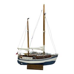 Scratch built model yacht 'Rue de la mer', with painted blue and white hull, with acrylic case, model H67.5cm