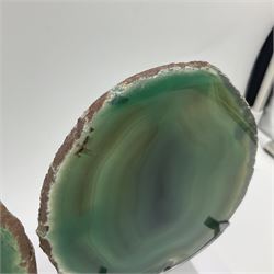 Pair of green agate slices, polished with rough edges, raised upon silvered metal stands, H20cm