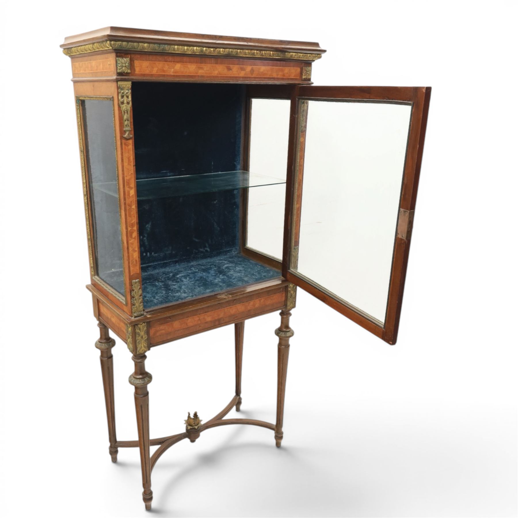 French kingwood display vitrine, rectangular glazed case with baized lined interior, parquetry banding and gilt metal bead mounts, applied gilt metal foliate corner mounts, raised on turned supports united by shaped undertier stretchers