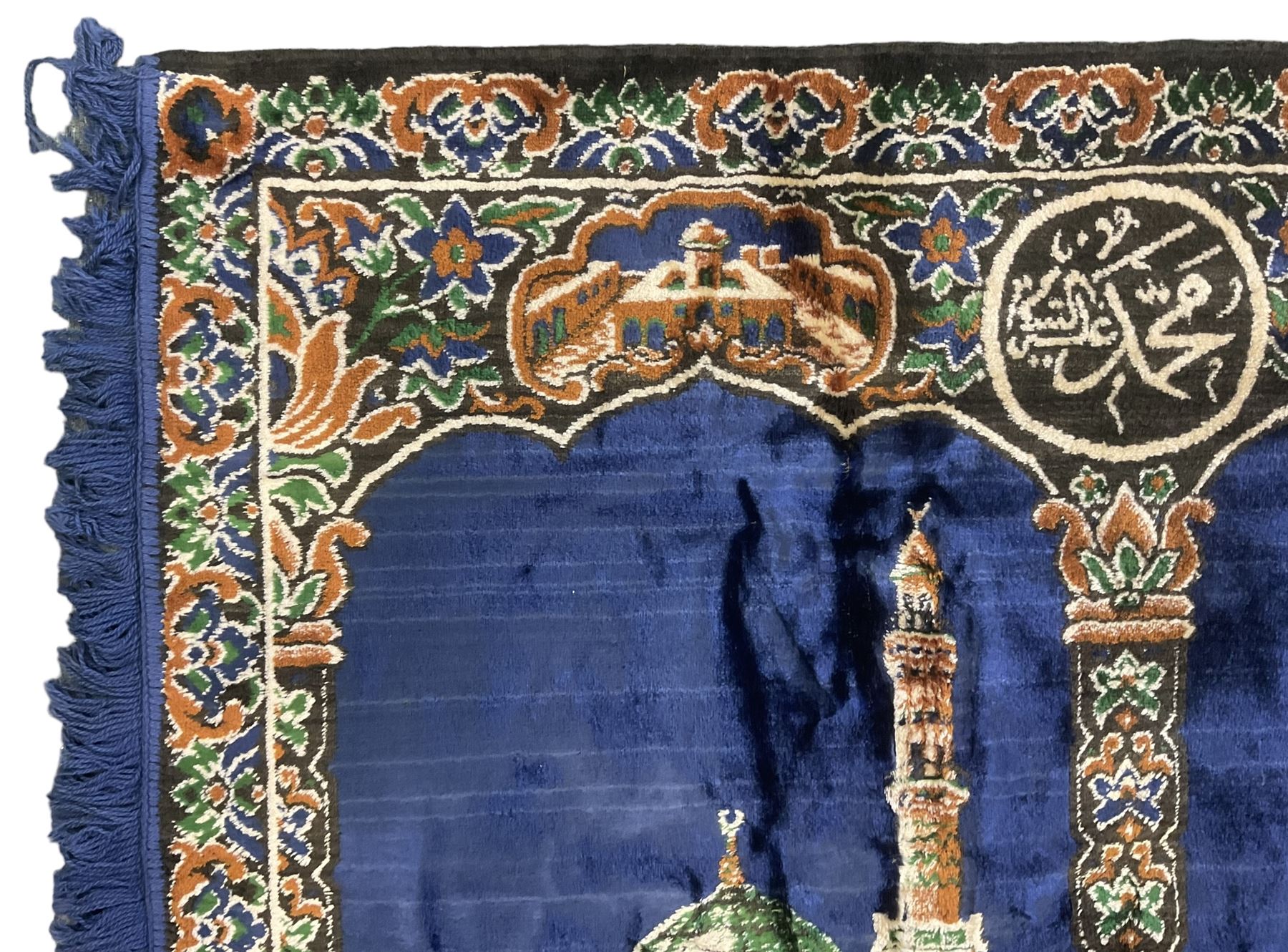 Indigo ground family prayer rug, depicting Masjid al-Haram in Mecca within floral design borders 