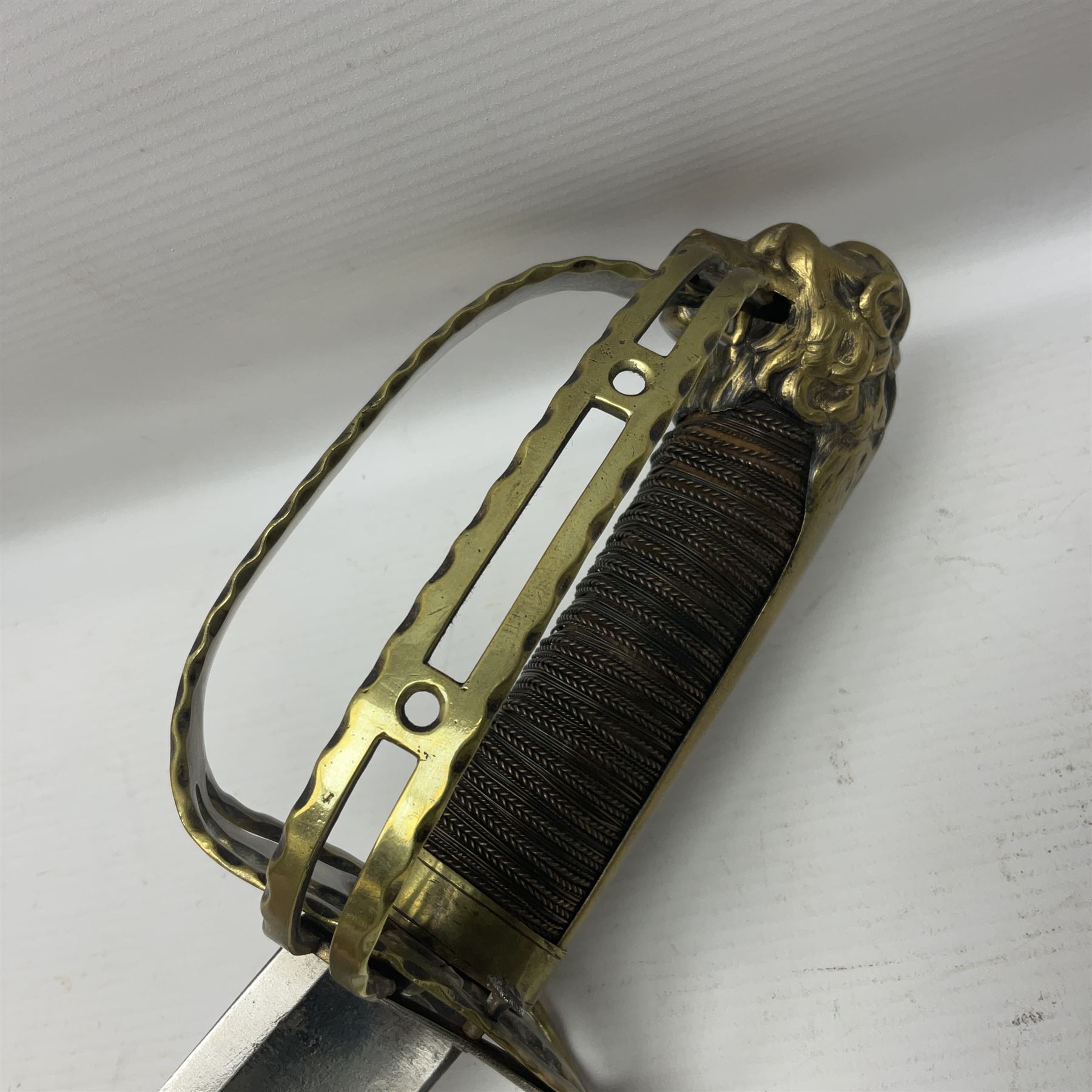 Late 18th century French 1st Empire Troupe a Pied Petit Montmorency Branch Tournante officer's sword, with 72.5cm slightly curving fullered blade, pierced brass hilt with lockable swivelling bar, fully wire-bound grip with lion head pommel, L88cm overall (no scabbard)