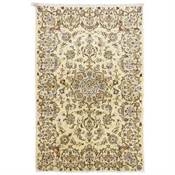 West Central Persian Sarough hand-knotted rug, ivory field with central lobed medallion is...