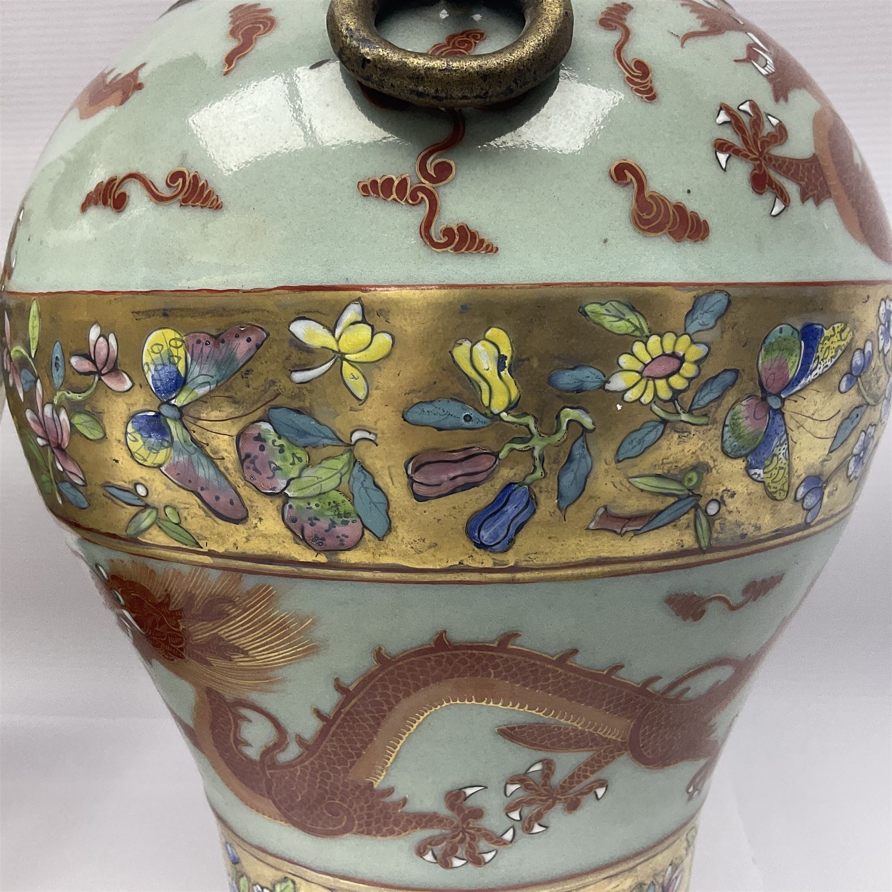 Pair of early 20th century Chinese vases decorated with dragons chasing a flaming pearl, with a gilt border of butterflies and floral sprigs, with Elephant head handles, H44cm 