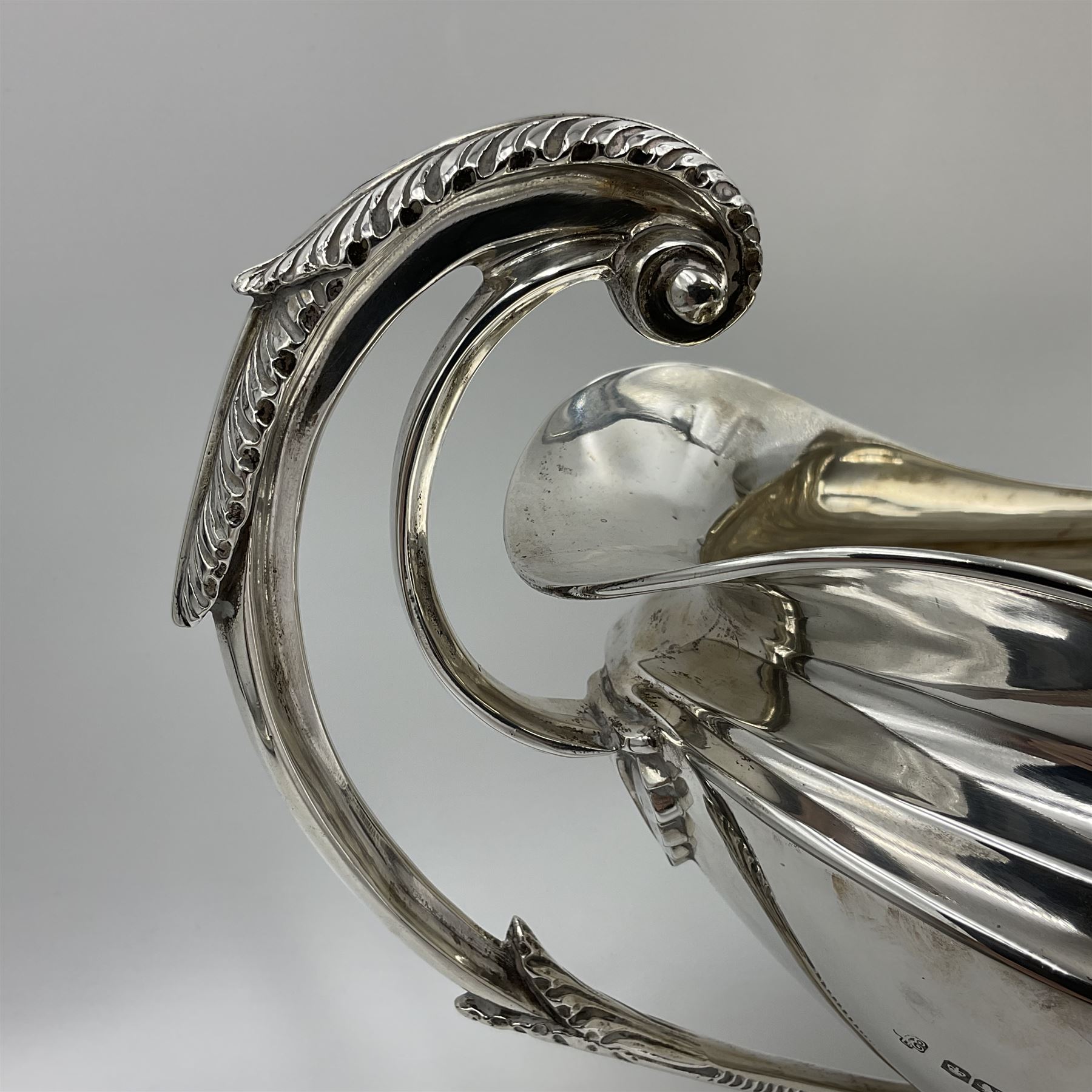 1920s silver twin-handled pedestal bowl, of navette form with twin bifurcated acanthus capped scroll handles, engraved with initial R to body and upon spreading oval foot, hallmarked Hawksworth, Eyre & Co Ltd, Sheffield 1925, including handles H21.8cm