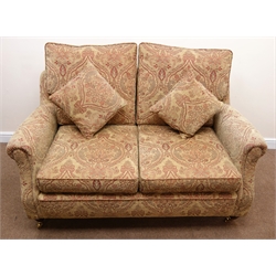  Two seat sofa upholstered in beige floral patterned chenille fabric, turned supports, brass castors (W155cm) a pair matching armchairs (W84cm) and storage footstool (3)  