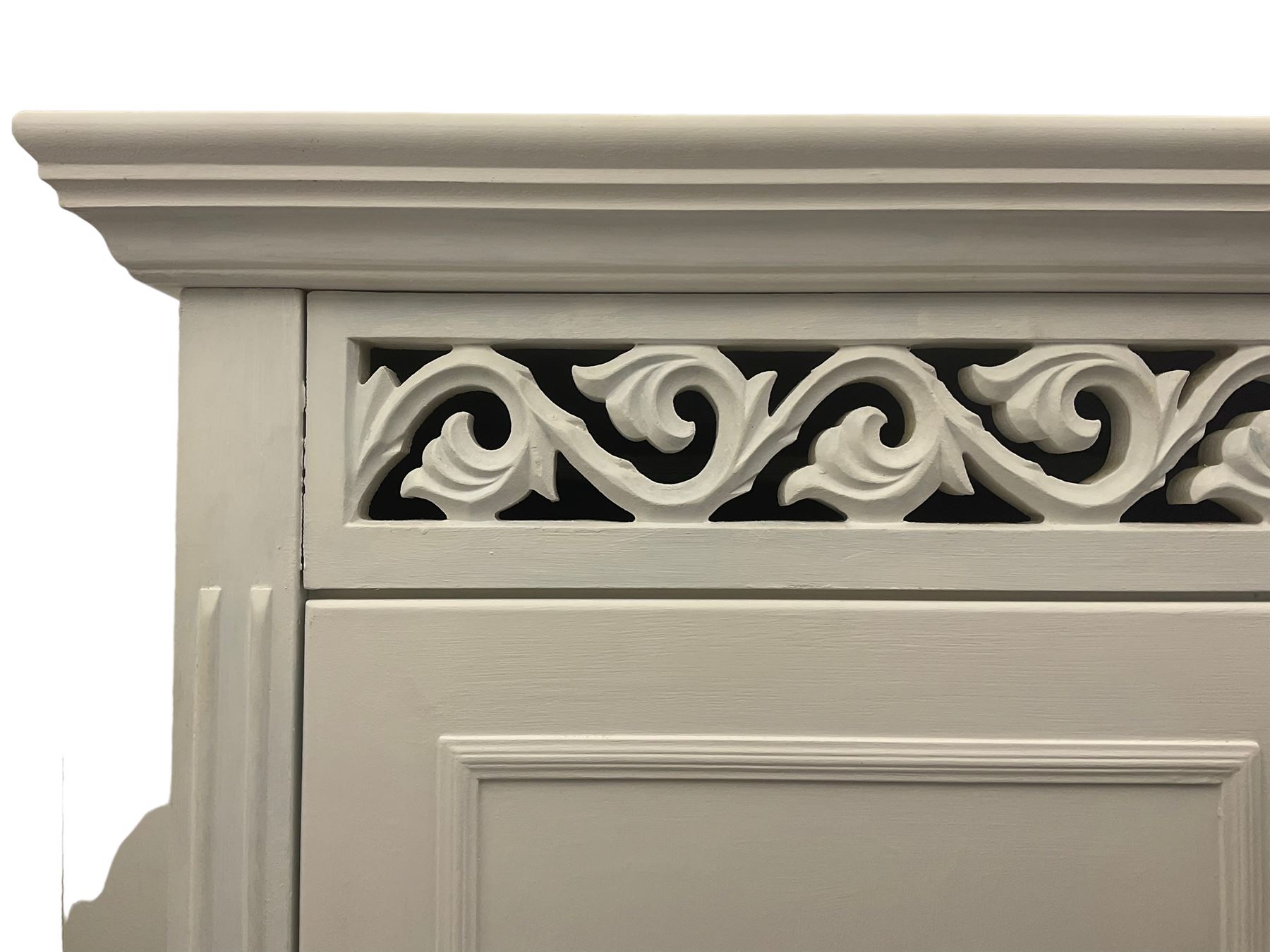 White painted double wardrobe, pierced scrolling foliate frieze over two doors enclosing hanging rail and two shelves, two drawers fitted to base, with blue ceramic handles