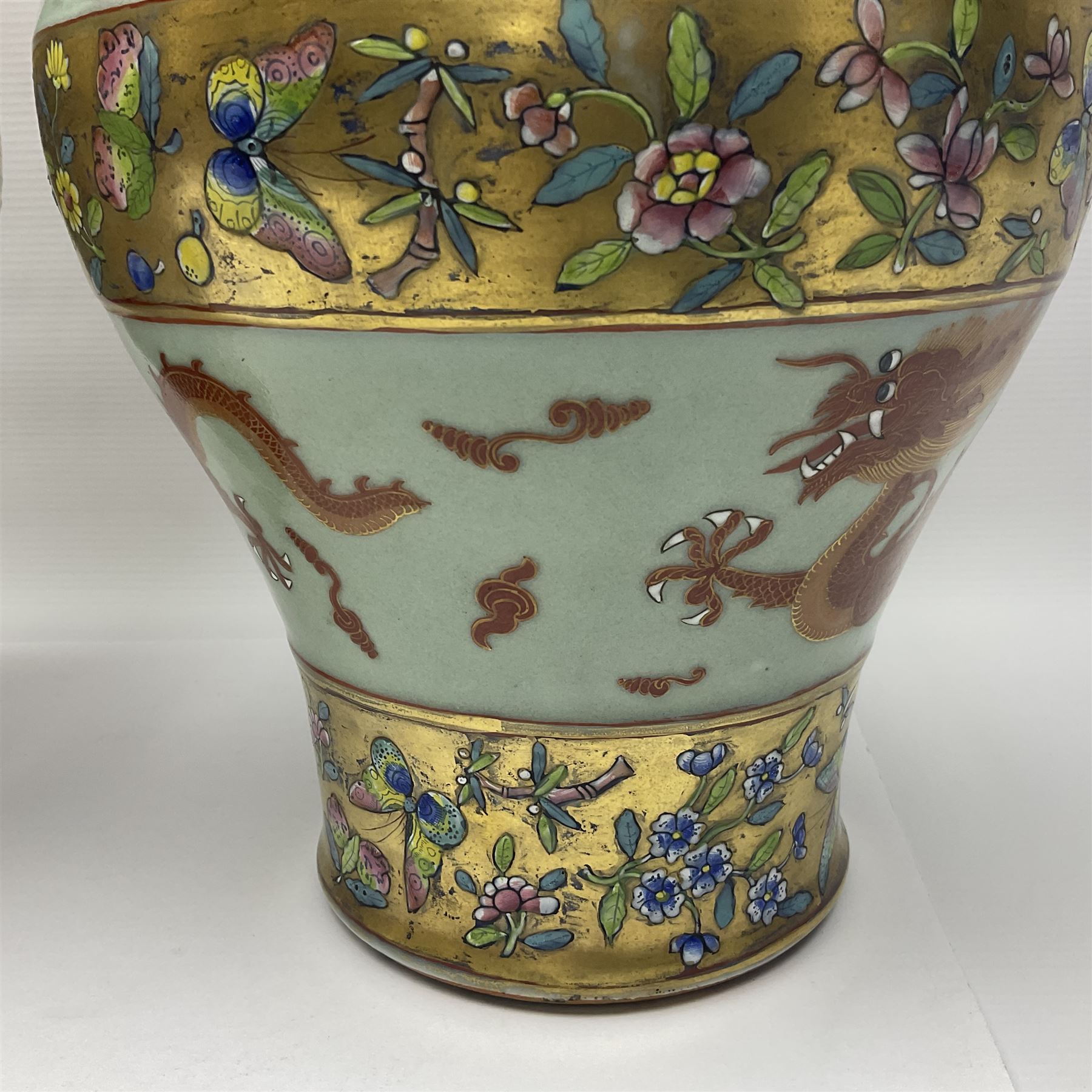 Pair of early 20th century Chinese vases decorated with dragons chasing a flaming pearl, with a gilt border of butterflies and floral sprigs, with Elephant head handles, H44cm 