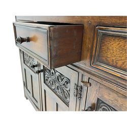 20th century carved oak court cupboard, s-scroll carved frieze over panelled cupboard door carved with arch, lobe and scroll carved cup and cover supports, fitted with three drawers and three cupboards below