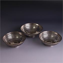 Three 1930s silver bon bon dishes, comprising pair and one larger example, each of circular form with pierced latticework sides, hallmarked Maxfield & Sons Ltd, Sheffield 1936, largest D12cm