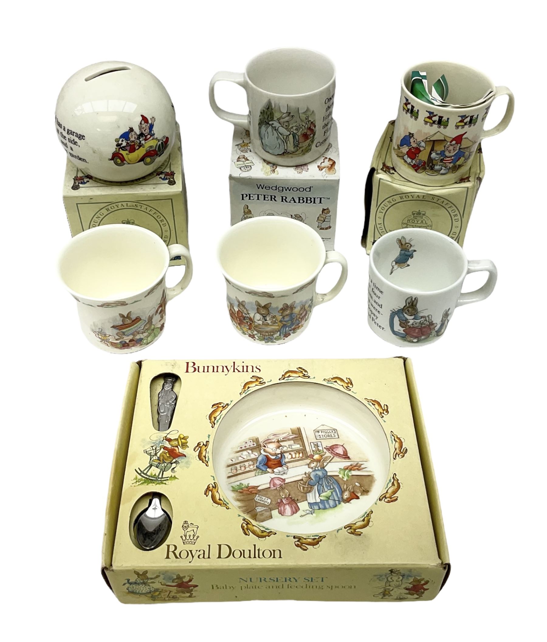 Royal Doulton Bunnykins nursery set in box and two cups, together with two Wedgwood Peter Rabbit mugs and Royal Staffordshire Noddy money box and cup (7)