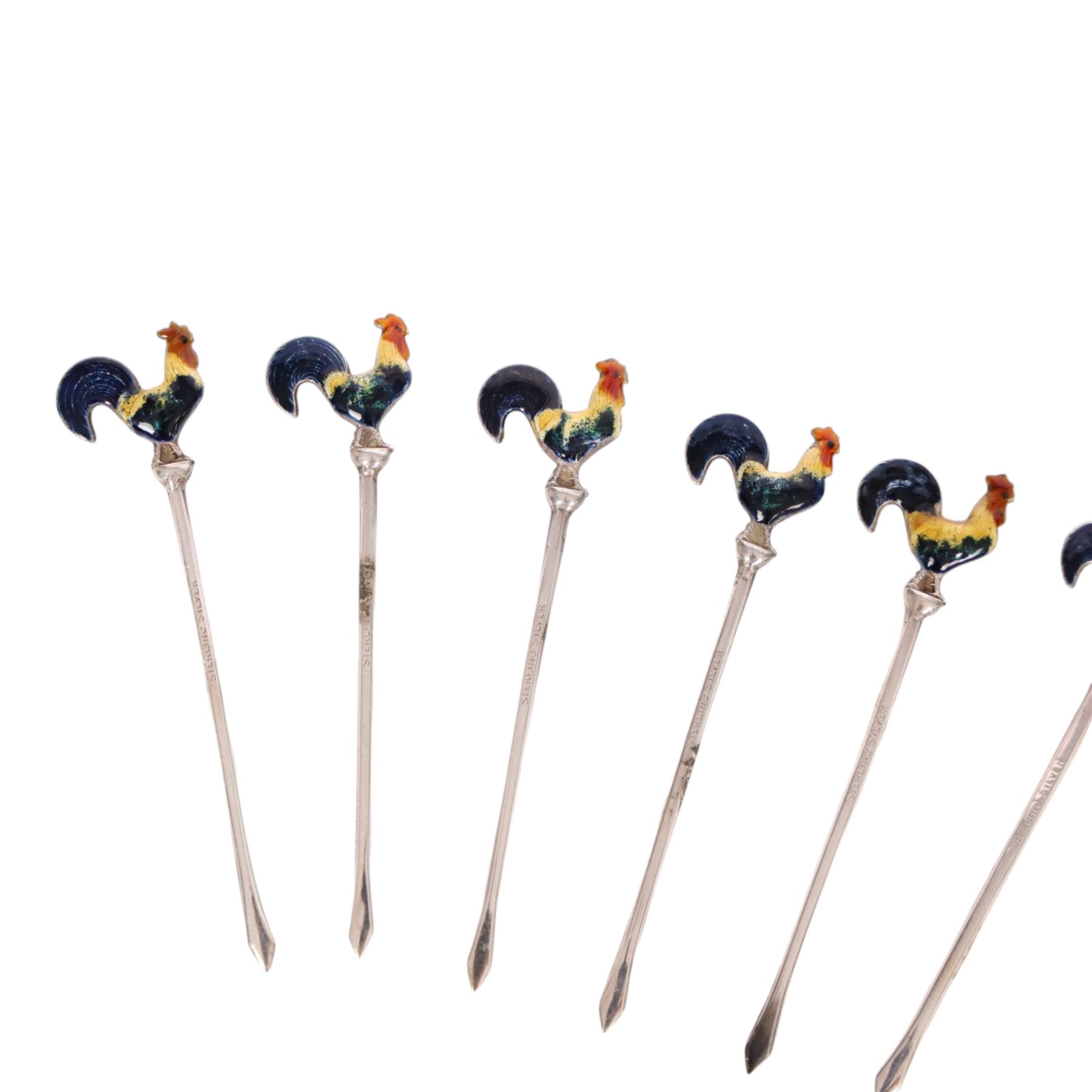 Set of six early 20th century silver cocktail sticks with enamel cockerel finials, stamped Sterling Silver