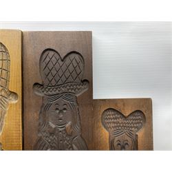 Six 20th century hardwood Dutch folk art Speculaasplank or biscuit moulds, typically carved with figures in traditional dress, largest H101cm