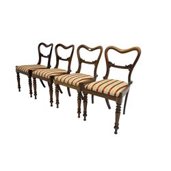 Set four late 19th century rosewood dining chairs, the balloon backs with scroll carved centre rail over upholstered drop-in seats, raised on tapered lappit carved supports