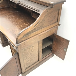 Early 20th century oak shaped tambour roll top desk , five graduating drawers, single cupboard interior, plinth base, W138cm, D87cm