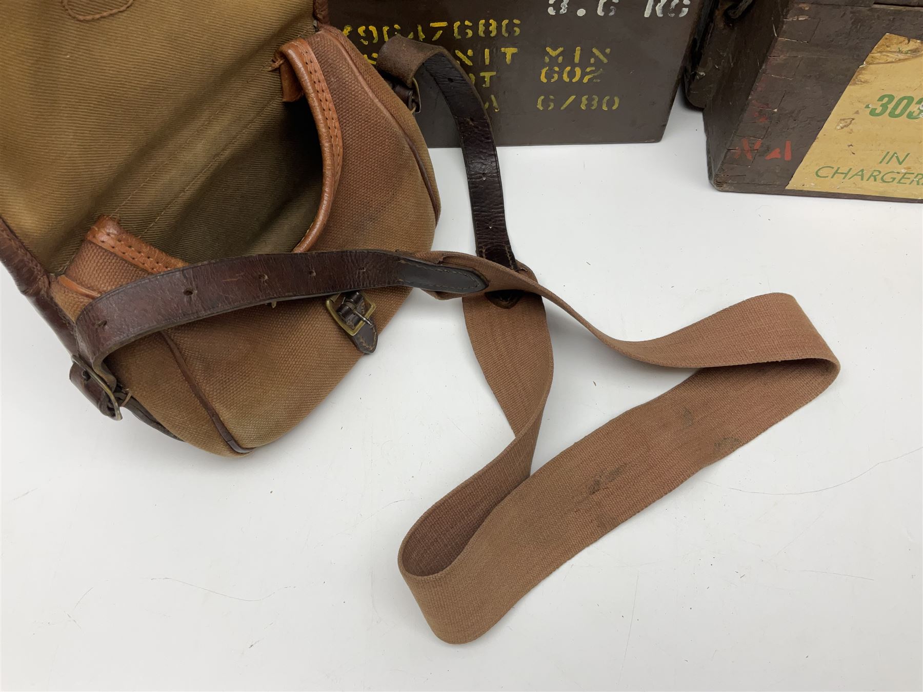 Miscellaneous shooting accessories - W.J. Bowman & Sons clay pigeon launcher; two leather cartridge belts; three cartridge bags; two canvas/leather game bags; and two metal/wooden cartridge boxes