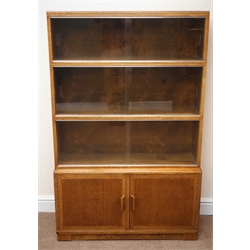  20th century Minty Oxford oak stacking library bookcase, sliding glazed doors above two cupboards, plinth base, W90cm, H140cm, D29cm  