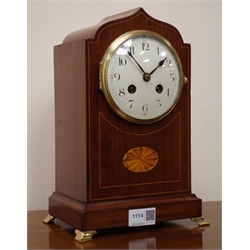  Edwardian inlaid mahogany serpentine top mantel clock with convex white Arabic dial, twin train movement half hour striking the hours on a gong, brass feet and bezel, H29cm   