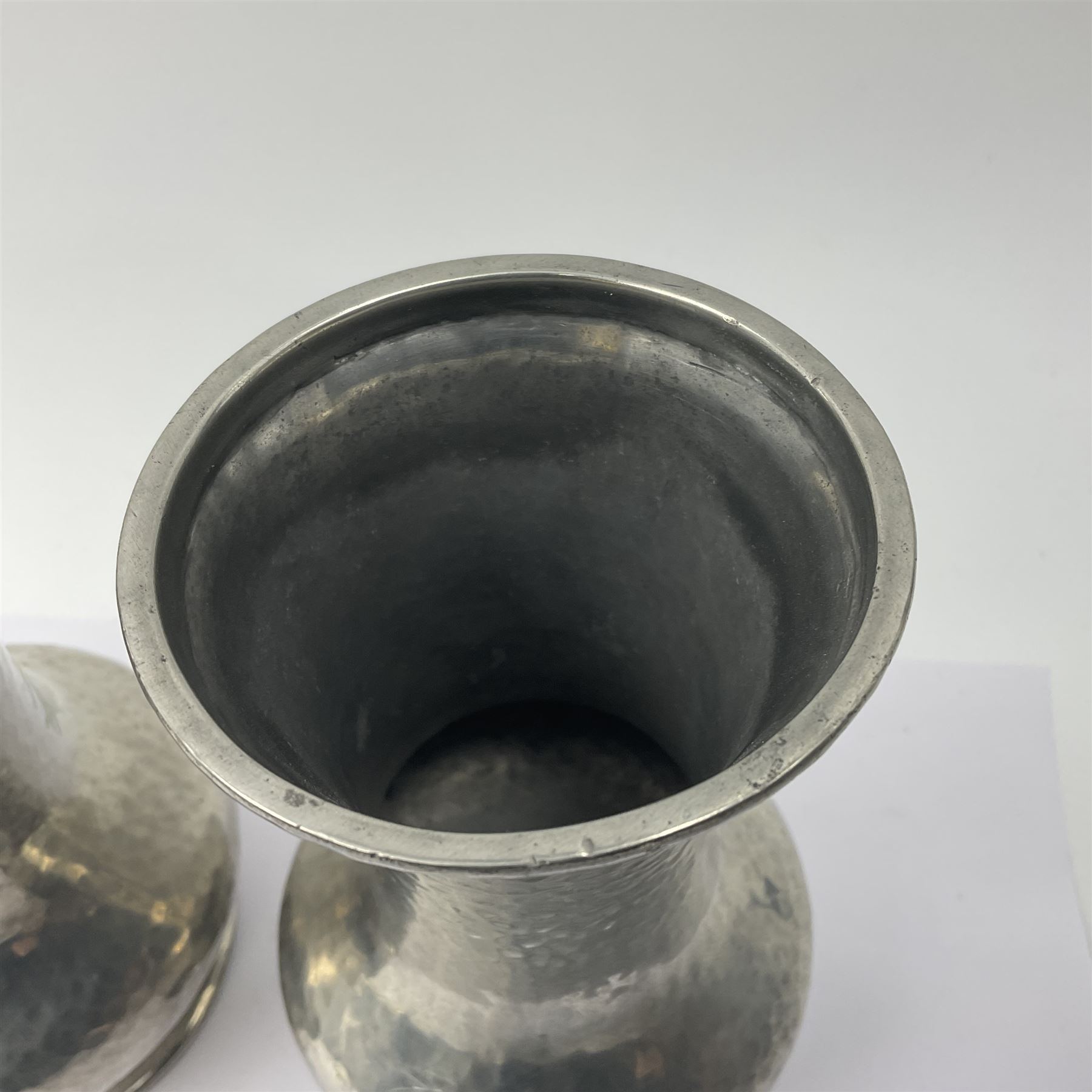 Pair of Liberty & Co Tudric pewter vases, each of bellied form with hammered finish, upon a circular spreading foot, impressed beneath 0987, H12cm