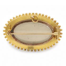 19th / early 20th century gold Etruscan Revival oval brooch, set with a single old cut diamond of approx 0.20 carat, surrounded by wirework and bead decoration, stamped 15ct
