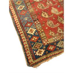 Old Caucasian Genje crimson ground runner, the field decorated with repeating Boteh motifs, the main border decorated with geometric motifs 