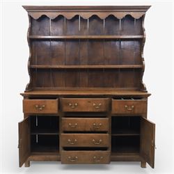 Georgian design oak dresser, the raised plate rack with shaped sides and two open shelves, upon a dresser base fitted with six drawers and two cupboard doors, and short block feet 