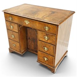 George III figured walnut kneehole desk, the rectangular top with feather and cross-banding with moulded edge, fitted with single frieze drawer over pierced spandrels and recessed cupboard, flanked by six graduating drawers, raised on bracket feet
Provenance: Kirkham Hall