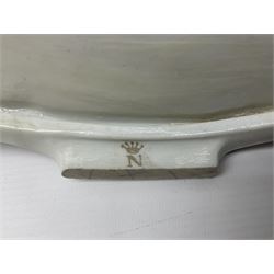 20th century Naples figure group, modelled as a seated female figure playing the lute seated, before a male figure stood holding a sheet of music, each in period dress, upon an oval base with gilt heightened scroll edge, with crowned N mark beneath, H31.5cm L33cm
