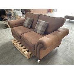 Two seat sofa upholstered in studded and buttoned suede fabric, scrolling arms, turned supports