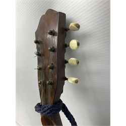 Late 19th/early 20th century Italian lute back mandolin with segmented back and spruce top; bears maker's label for Pietro Tonelli Napoli; together with a mandolin instruction booklet and a folding music stand L60.5cm