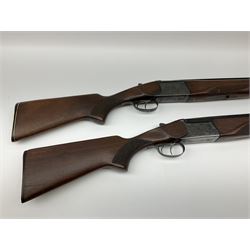 Two Russian Baikal 12-bore over-and-under double barrel boxlock non-ejector sporting guns; one with 68.5cm barrels, walnut stock with chequered pistol grip and fore-end and thumb safety, serial no.520545, L111cm overall; the other with 72.5cm barrels, walnut stock with chequered pistol grip and fore-end and thumb safety, serial no.012448, L114.5cm overall (2) SHOTGUN CERTIFICATE REQUIRED
