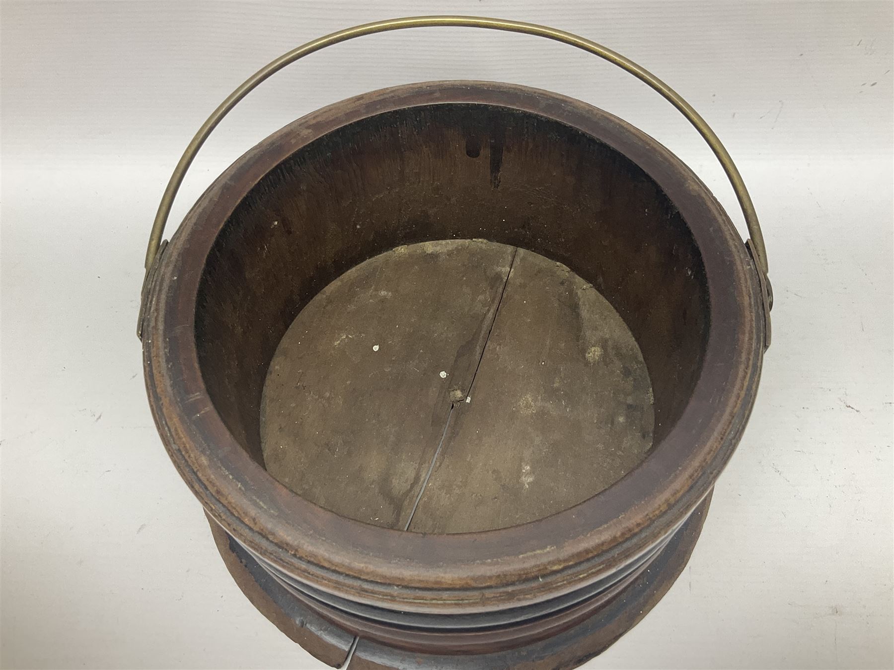  Georgian circular footwarmer with turned wood with decorative ebonised band, brass cover and swing handle, D25cm