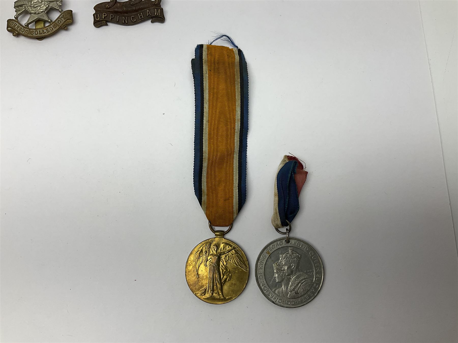 WW1 pair of medals awarded to 151761 Gnr. S. Loten R.A. with ribbons; four WW2 medals with ribbons; and small quantity of cap badges, medallions etc