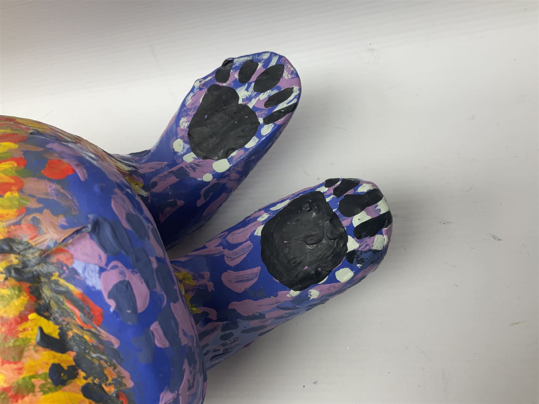 Helen Skelton (British 1933 – 2023): Two carved wooden abstract sculptures, one modelled as a dog, the other modelled as a bear, both with painted stippled decoration, largest H20cm. Born into an RAF family in 1933 in Kent and travelled the world extensively during her childhood. After settling in Bridlington, Helen immersed herself in painting, textiles, and wood sculpture, often inspired by nature's beauty. Her talent was showcased in a one-woman show at Sewerby Hall and recognised with the sculpture prize at Ferens Art Gallery in 2000. Sadly, Helen’s daughter passed away from cancer in 2005. This loss inspired Helen to donate her sculptures to Marie Curie upon her passing in 2023.