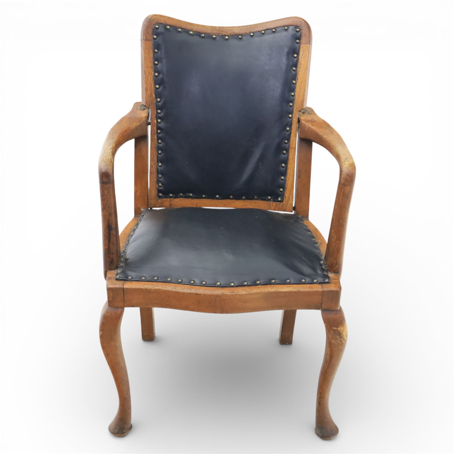 20th century oak recliner armchair, the curved back upholstered in leather with brass stud edging, hinged reclining back operated by side ratchet fittings, leather upholstered seat, shaped open arms, raised on cabriole legs
