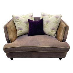John Sankey - two-seat contemporary shape hardwood-framed snuggler sofa, upholstered in leather and fabric with contrasting scatter cushions in pale ground fabric decorated with thistles, on turned front feet
