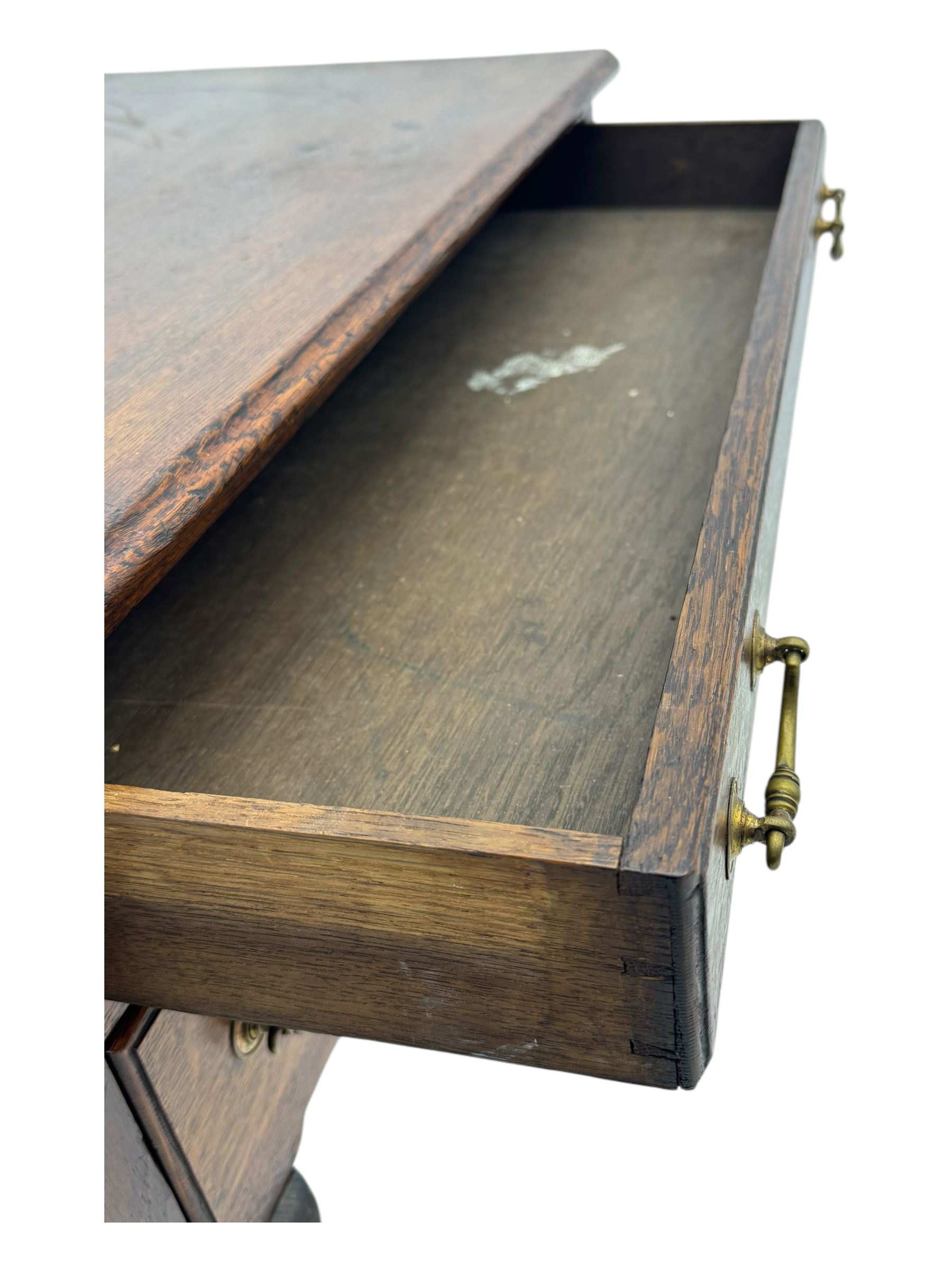 George II oak lowboy, moulded rectangular top over one long and two short drawers fitted with brass drop handles, shaped apron with scrollwork carvings, raised on cabriole supports