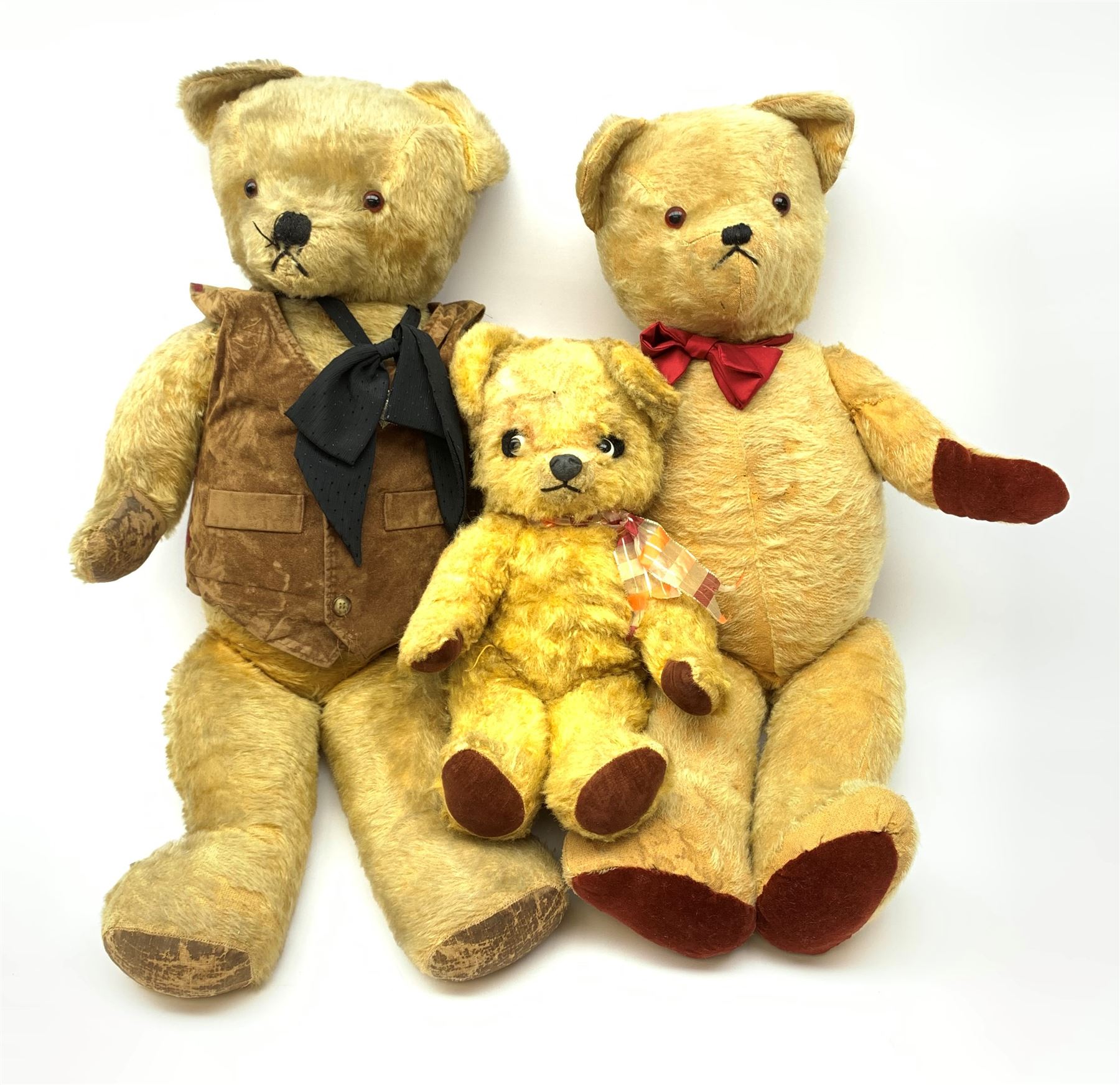 1950s English large wood wool filled teddy bear with swivel jointed head, glass type eyes and vertically stitched nose and mouth and jointed limbs with rexine paw pads H33