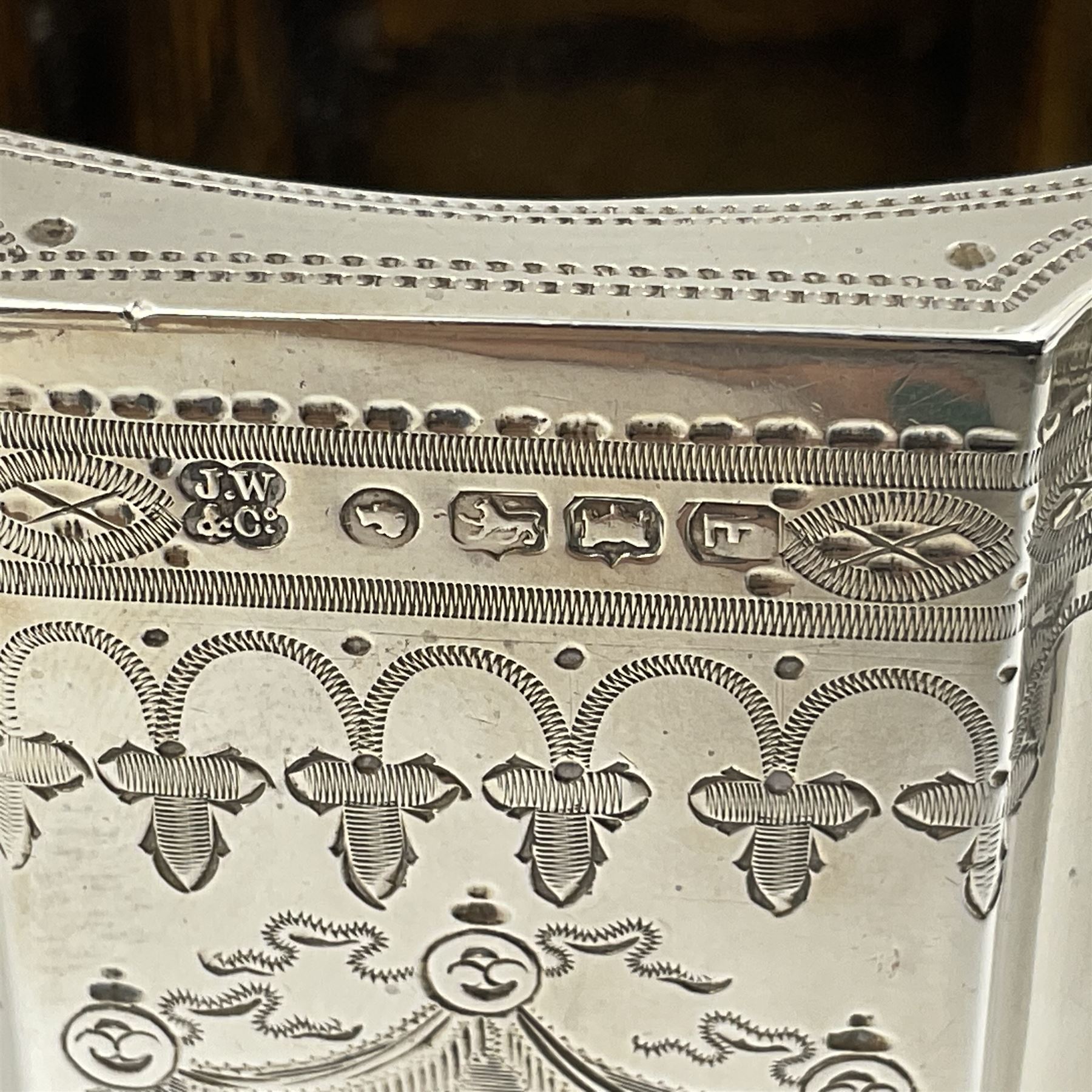 Victorian three-piece silver tea service, comprising teapot, twin handled open sucrier and milk jug, of oval form with shaped rim and C handles, each engraved with crests and bands of strapwork decoration, the milk jug and sucrier with gilt interiors, hallmarked Josiah Williams & Co, Exeter 1881, the teapot with ivory insulators and finial, all contained with a tooled leather, blue silk and velvet lined fitted case, retailed by West & Sun, Dublin 
This item has been registered for sale under Section 10 of the APHA Ivory Act