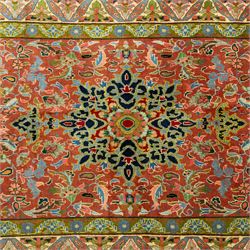 South Persian Sirjan hand-knotted carpet, terracotta ground, with a central shaped dark navy floral medallion with pendants, surrounded by scrolling foliate and floral motifs incorporating palmettes, rosettes and stylised vine work in blue, green and ivory tones, enclosed by dark navy spandrels and a wide green and ivory border with repeating palmettes and angular leaf motifs, flanked by patterned guard stripes, with cotton fringes