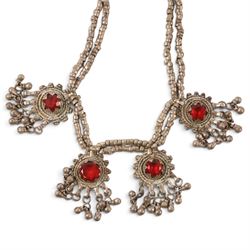 Collection of Middle Eastern jewellery, including silvered multi strand necklace with beadwork and filigree decoration with three cylindrical pendants, pendant necklace with central orange cabochon, beadwork choker and similar  