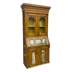 Late 19th century Aesthetic Movement period scumbled pine bureau bookcase, projecting cornice with fretwork frieze, enclosed by two glazed doors, panelled fall front over double cupboard, fretwork brass strap hinges 