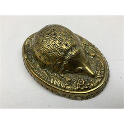 W Avery & Son brass oval pincushion in the form of a hedgehog, and horseshoe needle packet box both inscribed to base 'W. Avery and Son, Redditch', with registration mark, pin cushion L9cm 